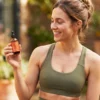 Person taking Slenderiiz Day Drops sublingual drops as part of daily wellness routine